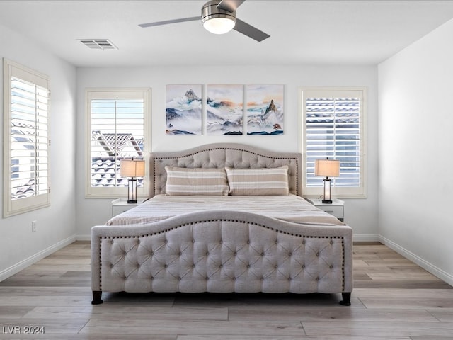 bedroom with ceiling fan and light wood-type flooring