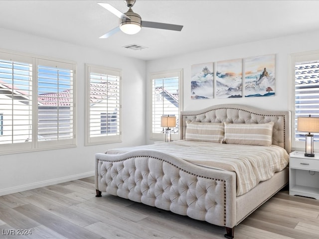 bedroom with ceiling fan and light wood-type flooring