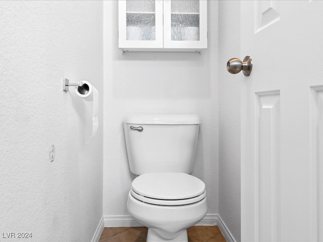 bathroom with tile patterned flooring and toilet