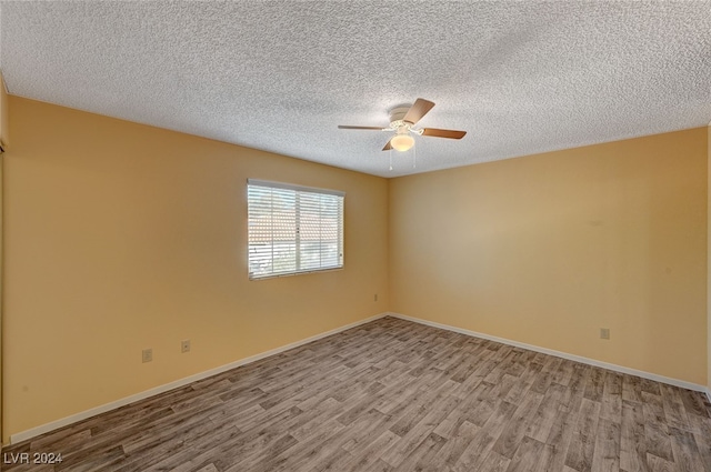 spare room with a textured ceiling, light hardwood / wood-style floors, and ceiling fan