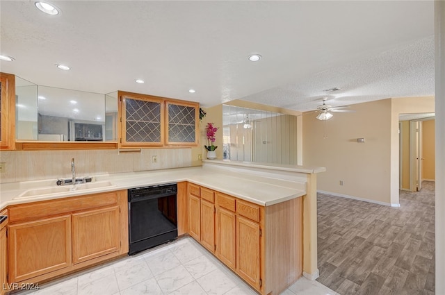 kitchen with kitchen peninsula, light wood-type flooring, ceiling fan, sink, and dishwasher