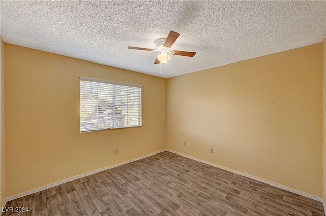 spare room featuring ceiling fan, hardwood / wood-style floors, and a textured ceiling