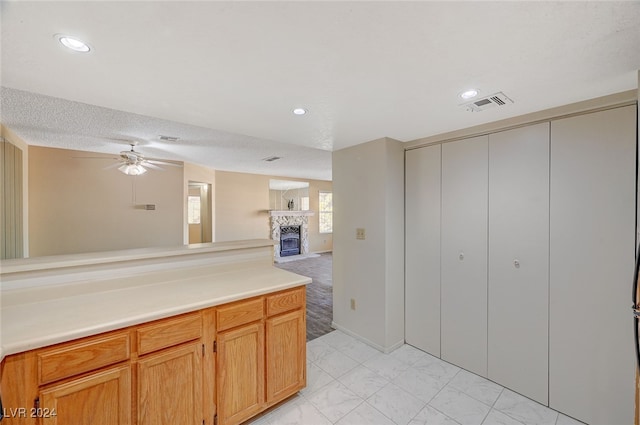 kitchen featuring ceiling fan and a textured ceiling