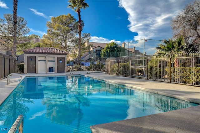 view of pool featuring a patio area and an outbuilding