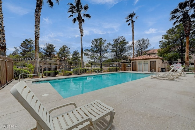 view of swimming pool with a patio area and an outdoor structure