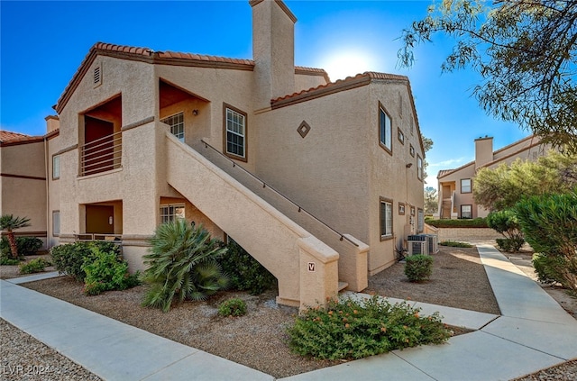 view of home's exterior with a balcony and central air condition unit