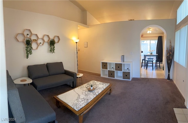 living room with vaulted ceiling and dark carpet