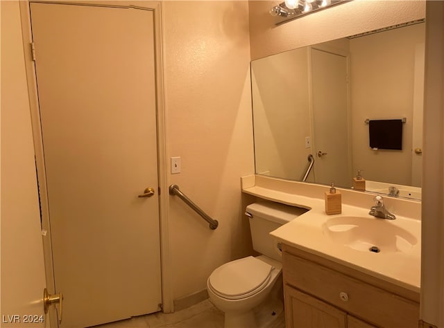 bathroom featuring tile patterned floors, vanity, and toilet