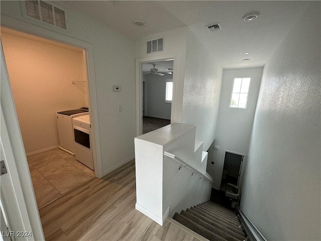 interior space featuring visible vents, washer and dryer, and wood finished floors