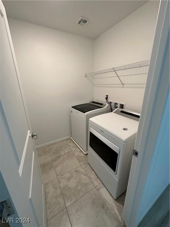 laundry room featuring laundry area, visible vents, baseboards, and separate washer and dryer