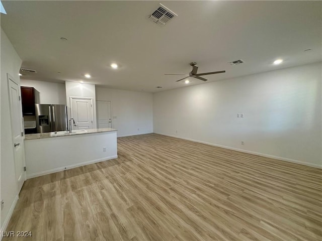 unfurnished living room with light wood-type flooring, ceiling fan, visible vents, and recessed lighting