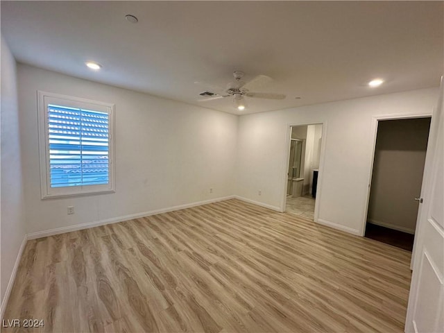 unfurnished room with baseboards, ceiling fan, visible vents, and light wood-style floors