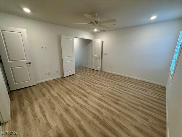 unfurnished bedroom with recessed lighting, light wood-type flooring, a ceiling fan, and baseboards