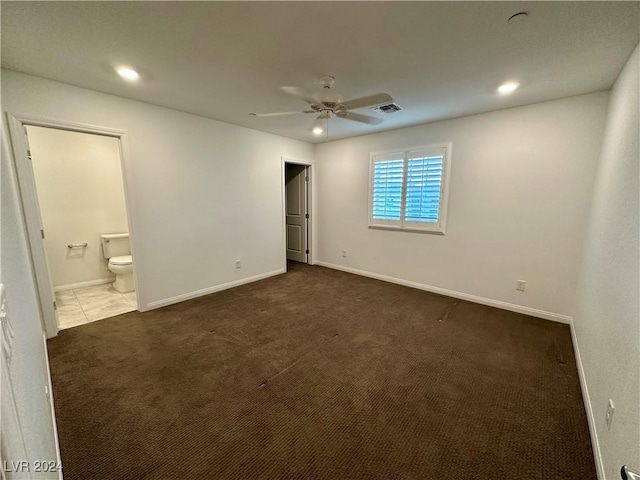 unfurnished bedroom with connected bathroom, baseboards, and carpet flooring