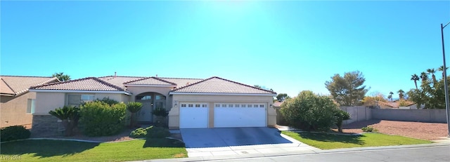 view of front of home featuring a garage and a front lawn