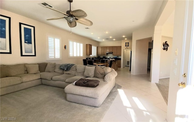 living room with light tile patterned floors and ceiling fan