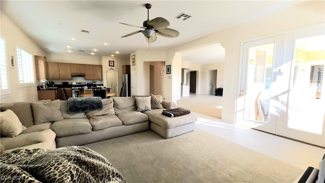 tiled living room with ceiling fan