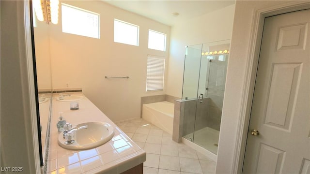 full bathroom featuring a bath, tile patterned flooring, a shower stall, and a sink