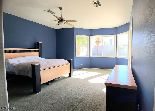 bedroom with ceiling fan, visible vents, and carpet flooring