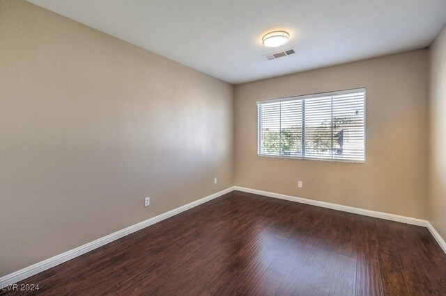 spare room with dark hardwood / wood-style floors