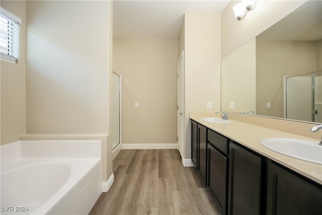 bathroom with separate shower and tub, hardwood / wood-style floors, and vanity