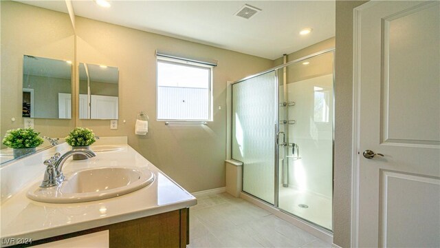 bathroom with a shower with door and vanity