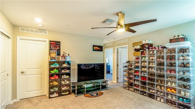 interior space with carpet floors and ceiling fan