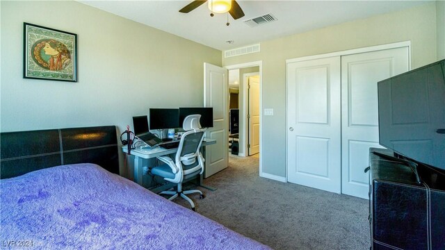 carpeted bedroom featuring a closet and ceiling fan