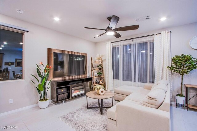 tiled living room with ceiling fan