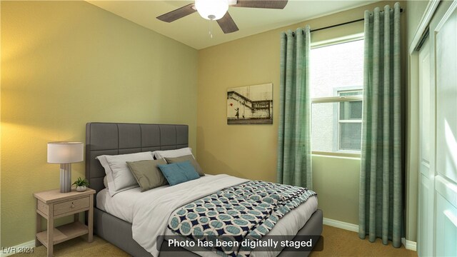 carpeted bedroom with ceiling fan and multiple windows