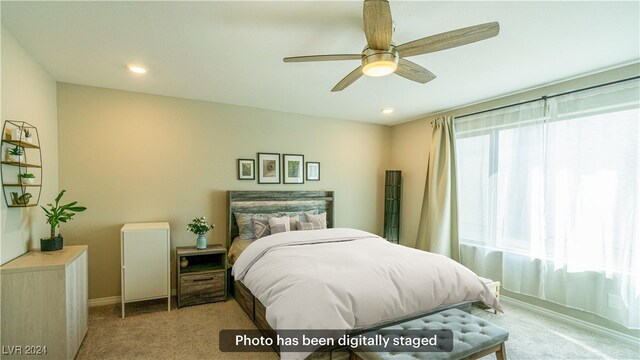 bedroom with ceiling fan and light colored carpet