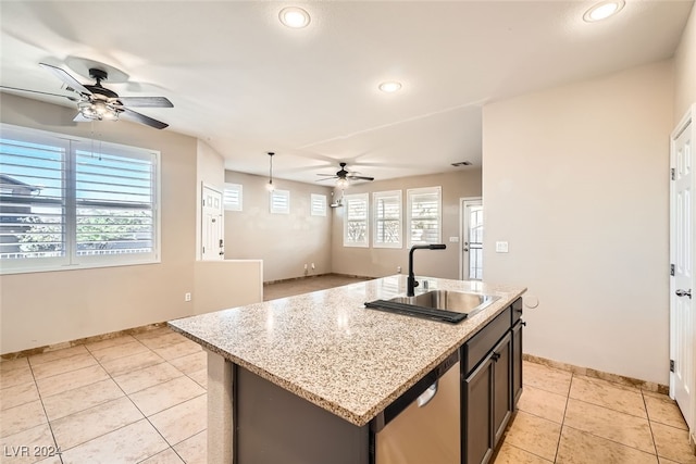 kitchen featuring ceiling fan, a kitchen island with sink, sink, decorative light fixtures, and dishwasher