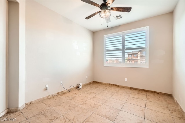 tiled empty room with ceiling fan