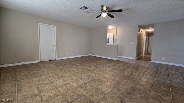 empty room with ceiling fan and a textured ceiling