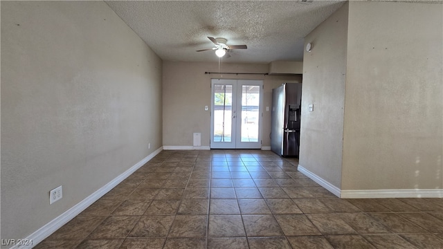 spare room featuring ceiling fan, french doors, and a textured ceiling