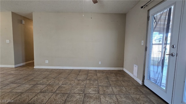 unfurnished room featuring a textured ceiling, plenty of natural light, and ceiling fan