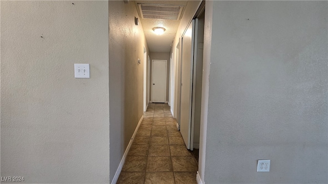 hall with light tile patterned flooring