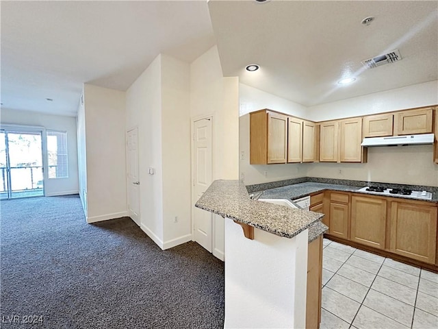 kitchen featuring visible vents, light carpet, a peninsula, white cooktop, and under cabinet range hood