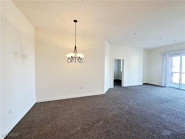 empty room with baseboards, dark carpet, and a notable chandelier