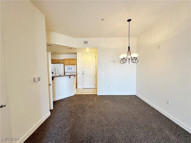 interior space with a chandelier, light colored carpet, visible vents, and baseboards