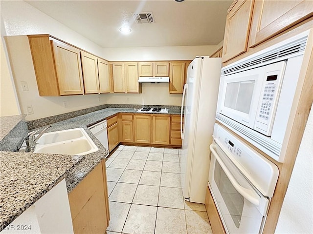 kitchen with visible vents, light brown cabinets, a sink, white appliances, and under cabinet range hood