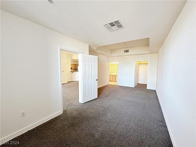 unfurnished bedroom featuring baseboards, visible vents, and carpet flooring