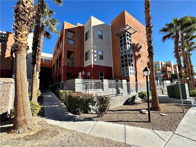 view of building exterior with fence