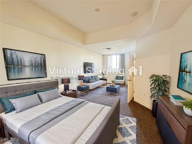 bedroom featuring baseboards, visible vents, dark colored carpet, and a raised ceiling