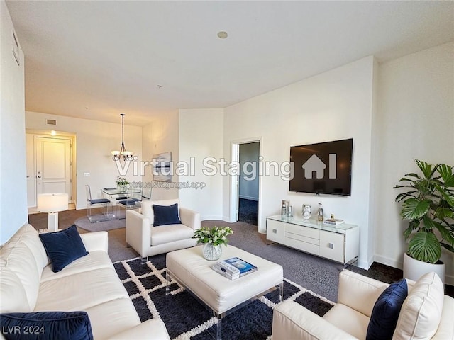 living room with carpet, visible vents, baseboards, and an inviting chandelier