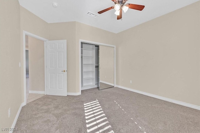 unfurnished bedroom with a closet, baseboards, carpet flooring, a ceiling fan, and visible vents