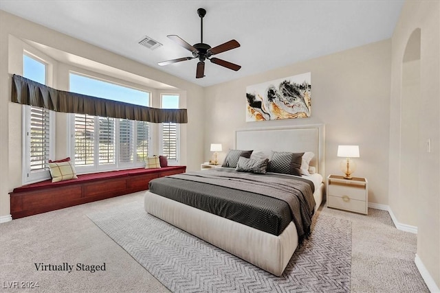 carpeted bedroom with baseboards, a ceiling fan, and visible vents