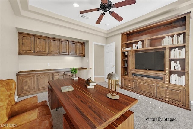 home office with visible vents, ceiling fan, and light colored carpet