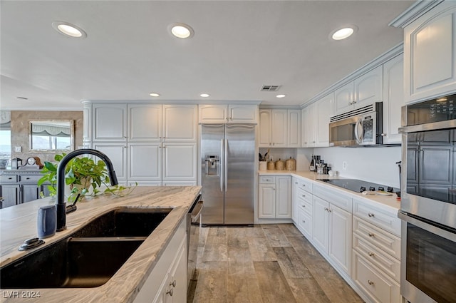 kitchen with white cabinets, appliances with stainless steel finishes, and sink