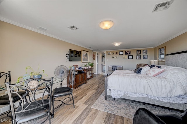 bedroom with light hardwood / wood-style floors and ornamental molding